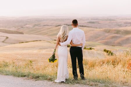 wedding couple travel tuscany at sunset. FIne art wedding photo. Destination wedding. Travelling italy on honeymoon.の写真素材