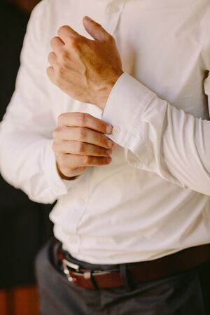 male wearing white shirt indoors