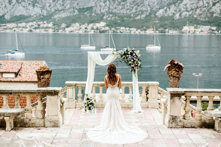 bride in luxury dress walk to the aisle with mountains and sea view . Destination wedding in Europe. Luxury bride. Montenegro, Kotorの写真素材