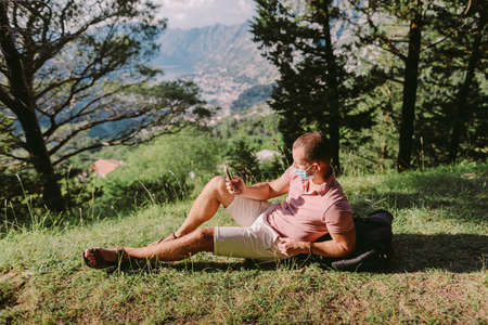 man travel wearing protective face mask in mountainsの写真素材