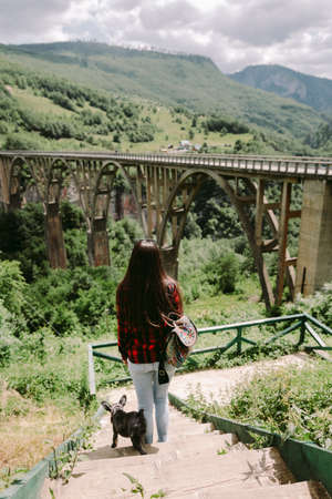 woman travel with dog at countryside with mountains viewの写真素材