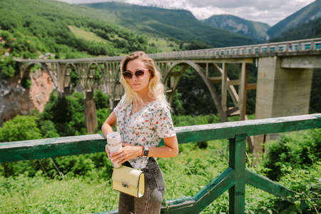 woman holding coffee mug in mountains on vacationsの写真素材