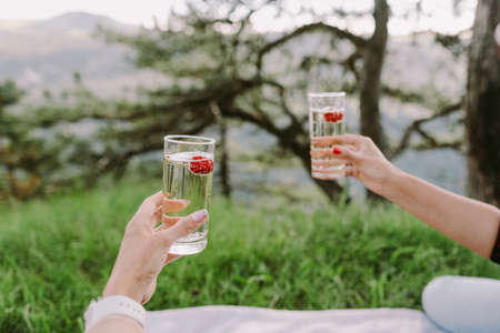 women drink cocktails outdoorsの写真素材