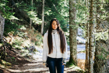 woman walk in winter forestの写真素材