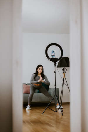 Fitness workout exercises online woman at home. Online fitness courseの写真素材