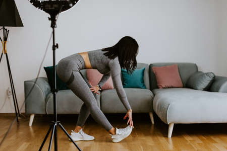 Fitness workout exercises online woman at home. Online fitness courseの写真素材