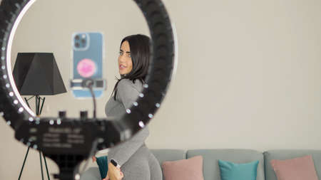Virtual online fitness. Woman virtual workout at home living room