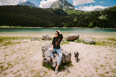beautiful woman relax in mountains and lake viewの写真素材