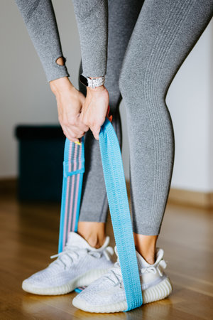 Fit woman fitness butt workout at home. elastic band workout