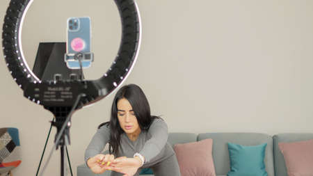 Virtual online fitness. Woman virtual workout at home living roomの写真素材