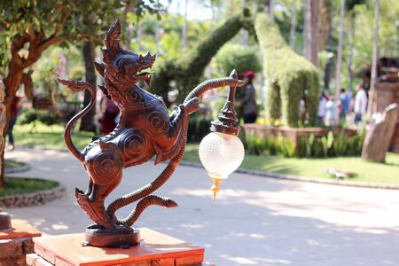 Singha (Thai mythical creature) with lamp in the gardenの写真素材