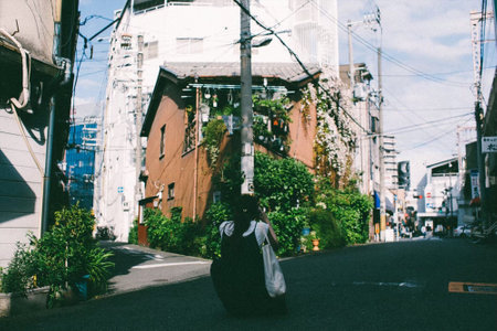 Woman crouching in alley and taking pictures