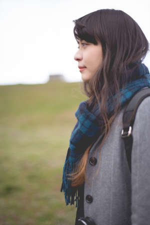 A woman with a muffler on the hand of the earthの写真素材