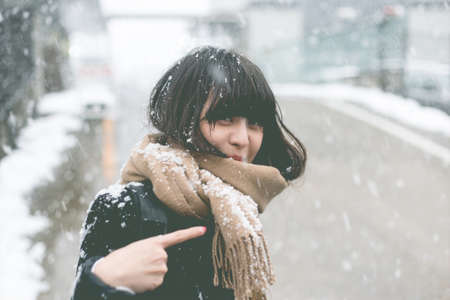 Snow on her hair and a smiling womanの写真素材