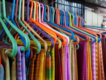 different coloured sarees on hangar for saleの写真素材