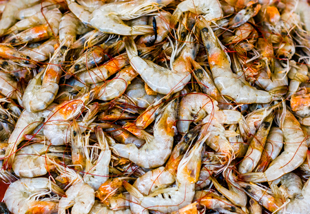 heap of golden white shrimps prawn lobster seafood for sale in fish market