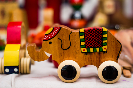 vintage colourful old wooden elephant toy on wheelsの写真素材