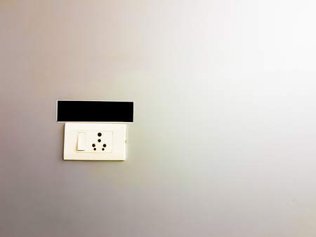 white switch board with multiple pin indian plug socket on a steel wallの写真素材