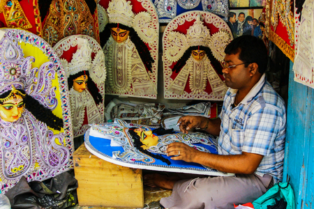 Kumartuli,West Bengal, India, July 2018.An artist working on a thermocol pattern of Goddess Durga at a shop. Durga puja is the most awaited hindu festival in eastern India and worldwide.のeditorial素材