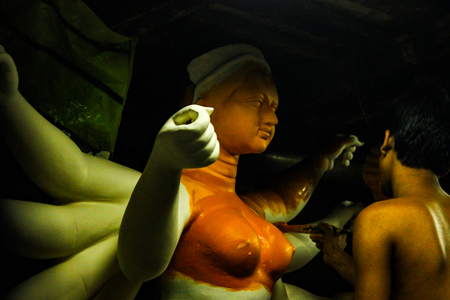 Kumartuli,West Bengal, India, July 2018.An clay scuplture artist working on a clay idol of Goddess Durga at a shop. Durga puja is the most awaited hindu festival in eastern India and worldwide.のeditorial素材
