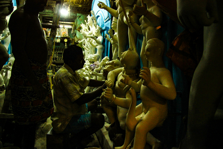Kumartuli,West Bengal, India, July 2018.An clay scuplture artist working on a clay idol of Goddess Durga at a shop. Durga puja is the most awaited hindu festival in eastern India and worldwide.のeditorial素材