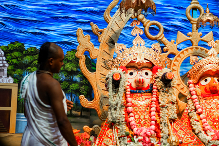 Durgapur, West Bengal, India. July, 2018 A Brahmin purohit panda staring at idol of Jagannath Balaram Suvadra at Rath Yatra Festival during Night. Rath Yatra is a very famous Hindu festival.のeditorial素材