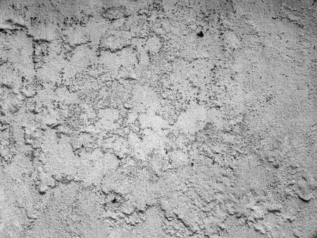 black and white rough cement wall texture with cracks, a background patternの写真素材