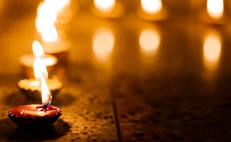candles lit on the occasion of deepavali, a hindu festival of light with selective focus on candle...