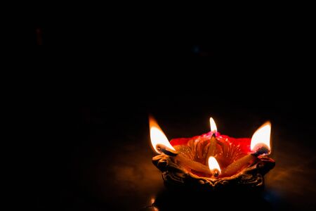 earthen oil lamp lit on the occasion of deepavali, a hindu festival of light with selective focus on...