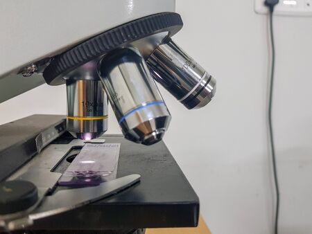 close up view of a light microscope with glass slide focussed