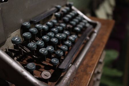 A closeup image of an old vintage type writer with eroded keys with selective focus on A S D W keys and background blur.の写真素材