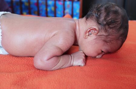 head holding exercise posture of a infant baby during tummy time.view from right.