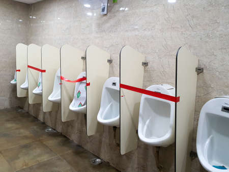 6th June 2020- Bagdogra Airport,Siliguri, West Bengal,India - Adjacent urinals blocked to maintain social distancing at Bagdogra Arport.のeditorial素材