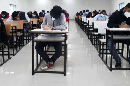 December 8, 2020.Lucknow Uttar Pradesh,India. West Bengal India. Medical students writing examination paper in mask maintaining social distancing at Radheshwam Medical College,Lucknow, UP, India.のeditorial素材
