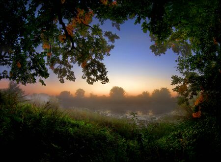 Landscape of morning sunrise with lake and forest. の写真素材