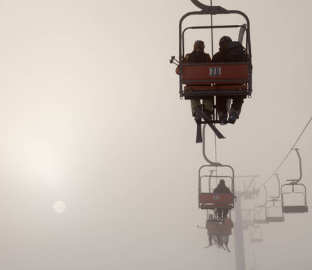 Ski lift at foggy mountains, tourism  winterの写真素材