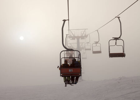 Ski lift at foggy mountains, tourism  winterの写真素材