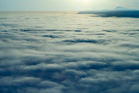 Peaks above clouds, winter mountains, foggy morningの写真素材