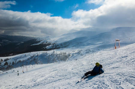 Skier in mountains, prepared piste and sunny day.の写真素材
