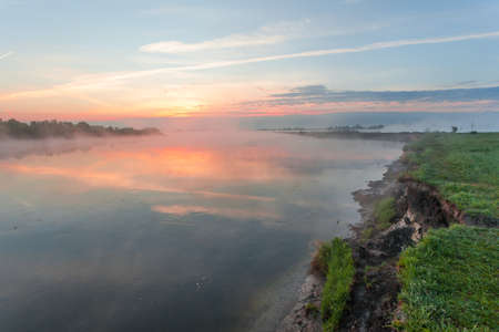 Reflection of the first rays of dawn sunlight in the lakeの写真素材