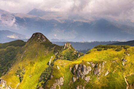 Summer landscape in mountains and the dark blue sky with clouds.
