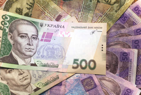 heap of different Ukrainian hryvnia in isolated background.