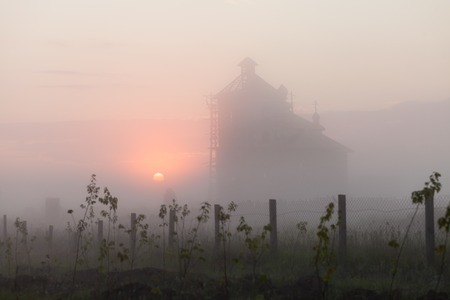A silhouette of a church steeple at sunsetの写真素材