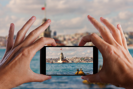 Travel concept. Hand making photo of city with smartphone camera. Istanbul. Turkey.の写真素材
