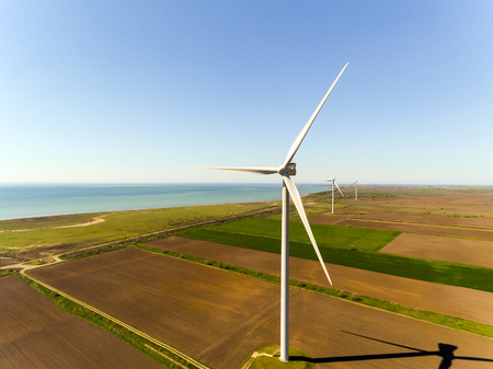 Aerial view looking across wind turbines in motion on a summers dayの写真素材