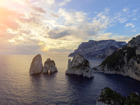 Faraglioni rocks towering up from bright blue Mediterranean waters on the island of Capri, Italyの写真素材