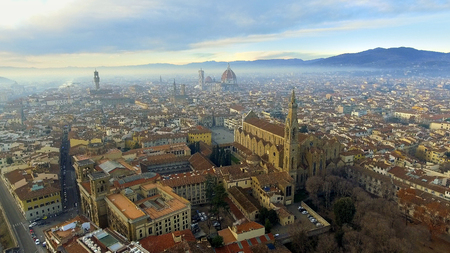 AERIAL. Panorama of the city of FLORENCE in Italy with the dome and Palazzo della Signoria and arno riverの写真素材