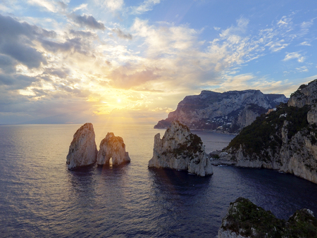 Faraglioni rocks towering up from bright blue Mediterranean waters on the island of Capri, Italyの写真素材