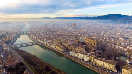 AERIAL. Panorama of the city of FLORENCE in Italy with the dome and Palazzo della Signoria and arno riverの写真素材