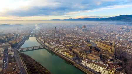 AERIAL. Panorama of the city of FLORENCE in Italy with the dome and Palazzo della Signoria and arno riverの写真素材